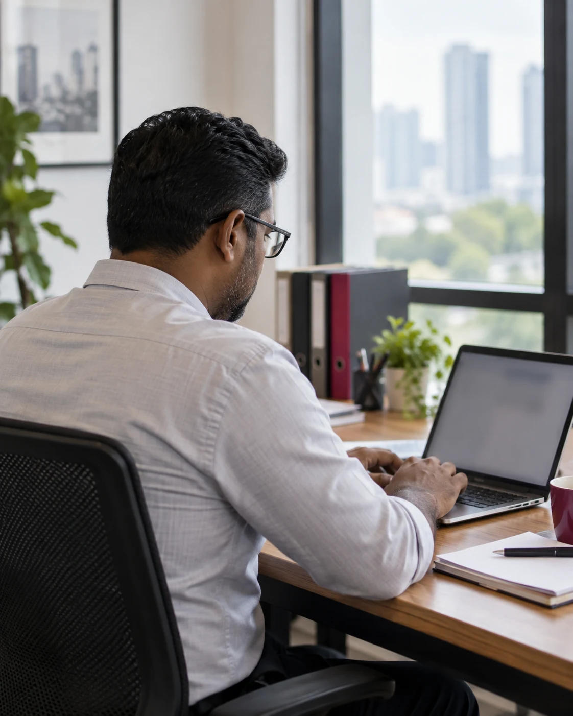 Growing SME owner accessing organised accounting records with an adviser